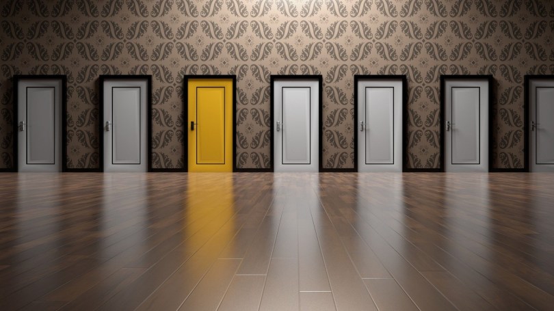 repeating white doors, one bright yellow door