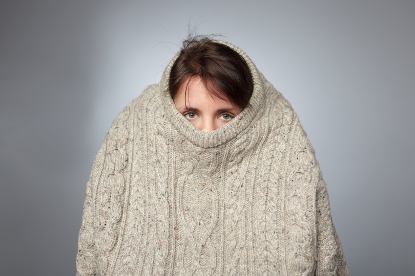 girl peeking out of big sweater