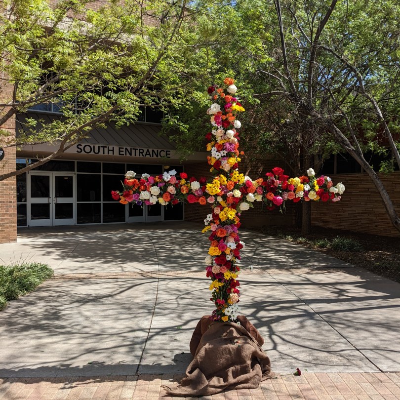 cross with flowers at church entrance