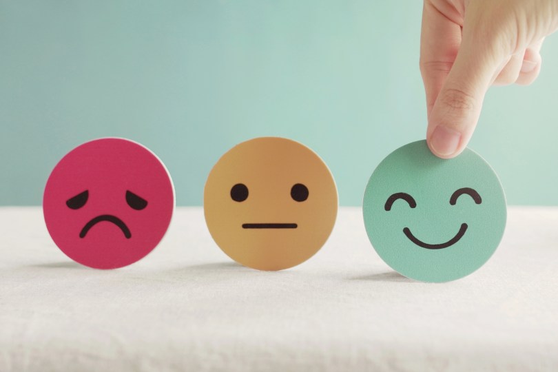 three faces, sad, nonchalant, and happy