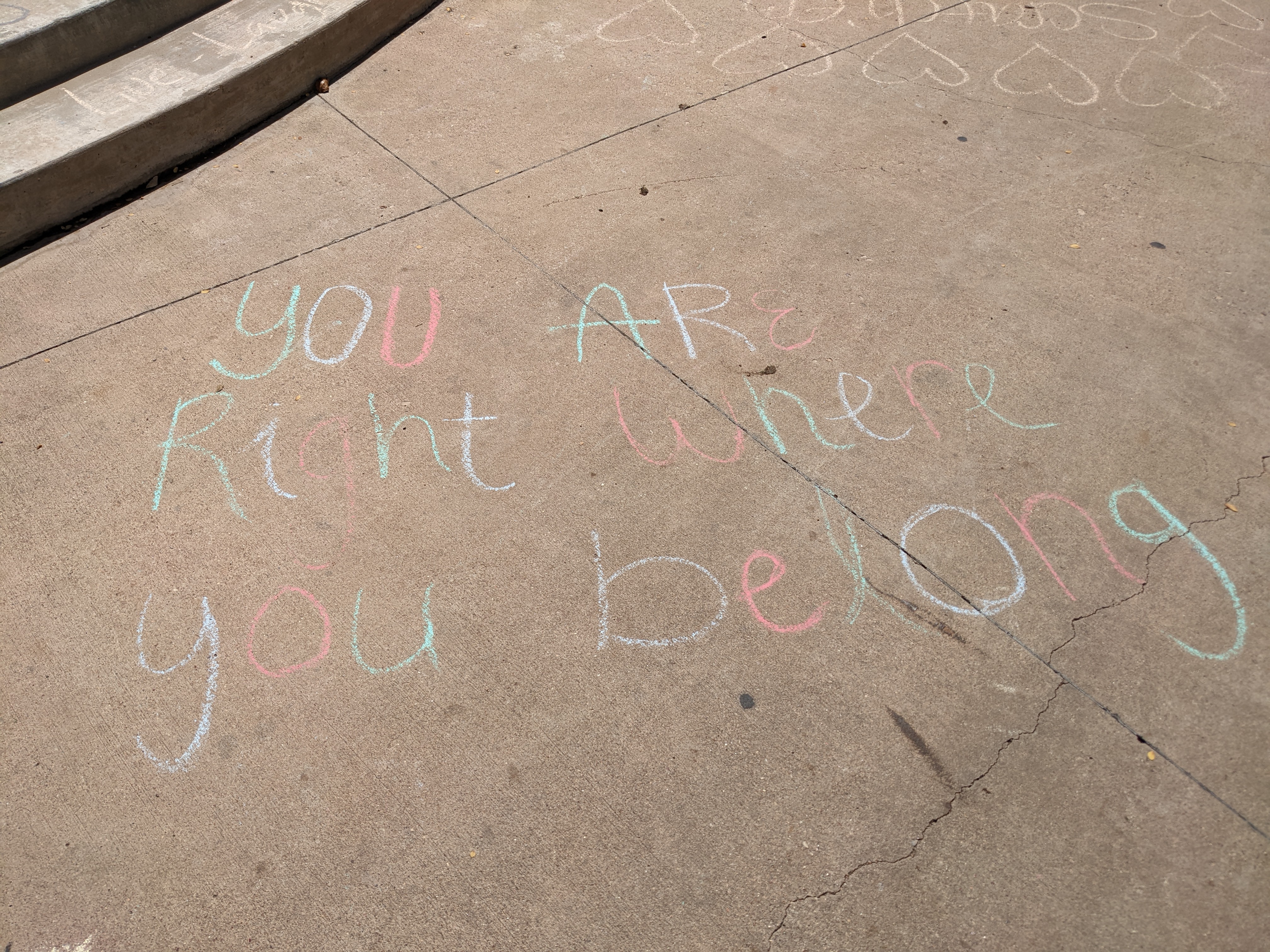 "you are right where you belong" in sidewalk chalk